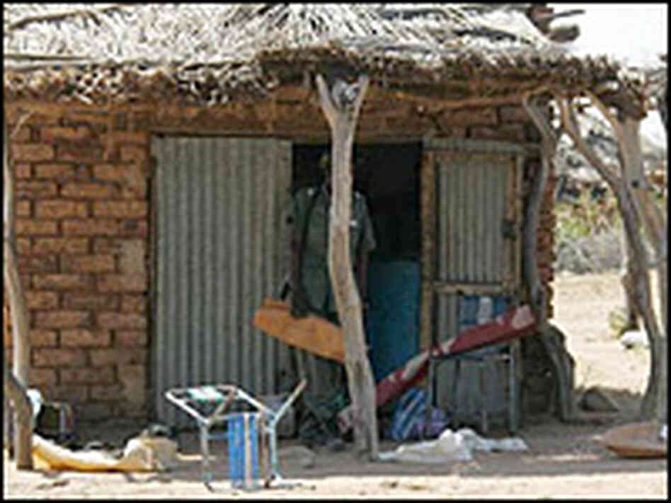 Sudanese government soldier emerges from a village store Sudanese government soldier emerges from a village store