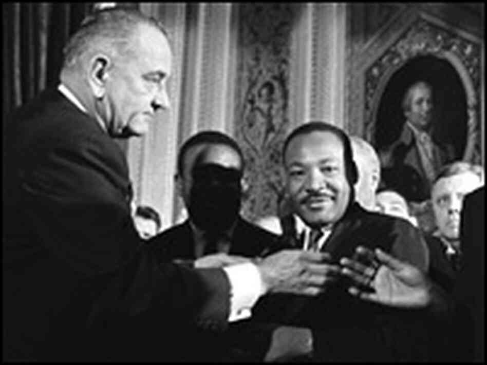 President Lyndon B. Johnson greets visitors as Rev. Martin Luther King, Jr., looks on. President Lyndon B. Johnson greets visitors as Rev. Martin Luther King, Jr., looks on.