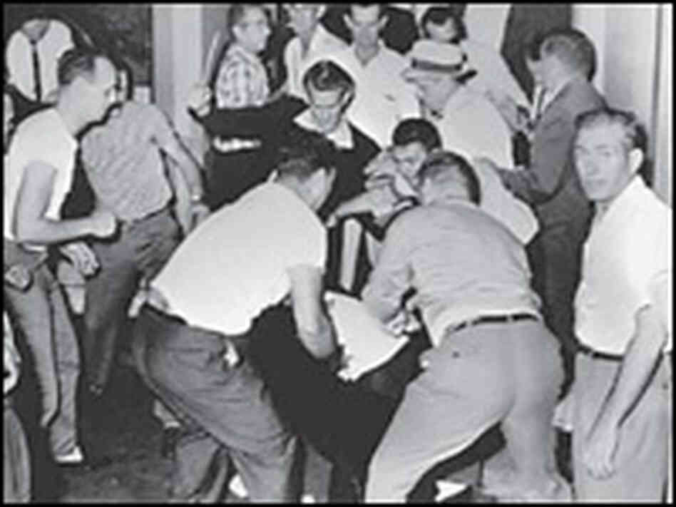 Ku Klux Klansmen beat black bystander George Webb in the Birmingham Trailways station, May 14, 1961.
