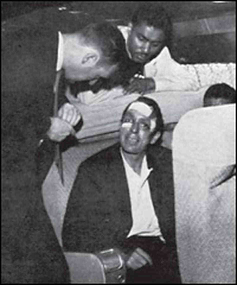 Jim Peck, seated, talks with a Justice Dept. representative and Ben Cox on the "freedom plane" to Ne Jim Peck, seated, talks with a Justice Dept. representative and Ben Cox on the "freedom plane" to Ne