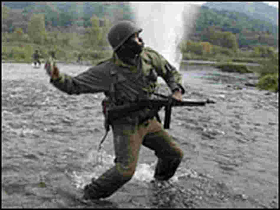 Laz Alonso and Derek Luke fight their way across a river