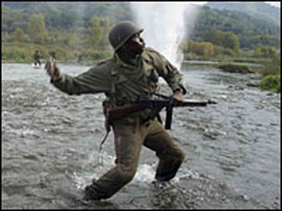 Laz Alonso and Derek Luke fight their way across a river