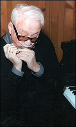 Toots Thielemans at piano, playing a harmonica. Photo by Dimitri Tolstoi