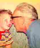 Joe Mitchell, 63, teaches his three-year old grandson Jonathan to whistle, Springfield, IL, 1974. Joe Mitchell, 63, teaches his three-year old grandson Jonathan to whistle, Springfield, IL, 1974.