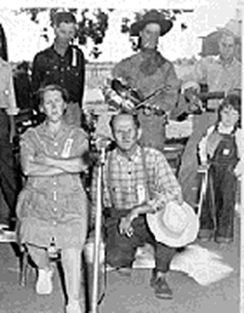 Frank and Myra Pipkins speak into a microphone, as a crowd looks on Frank and Myra Pipkins speak into a microphone, as a crowd looks on