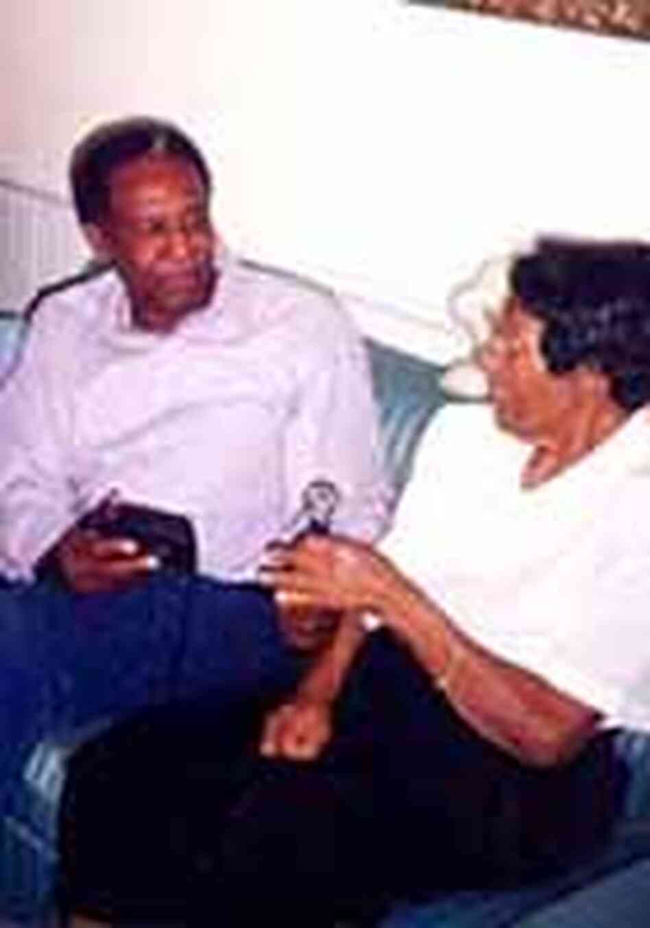 Eddie interviews Oxford resident, Martha Hammie, who is holding a microphone. Eddie interviews Oxford resident, Martha Hammie, who is holding a microphone.