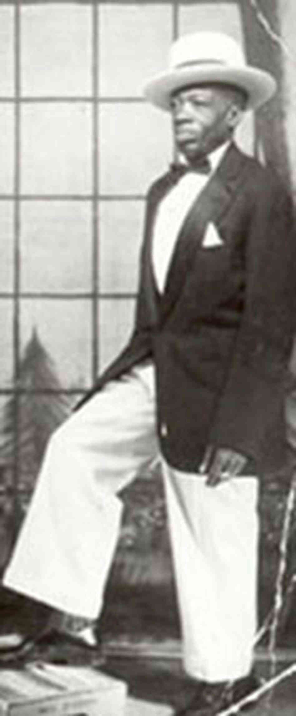 A formal looking DeFord Bailey posing with his foot on a Coca-Cola crate circa 1930s. A formal looking DeFord Bailey posing with his foot on a Coca-Cola crate circa 1930s.