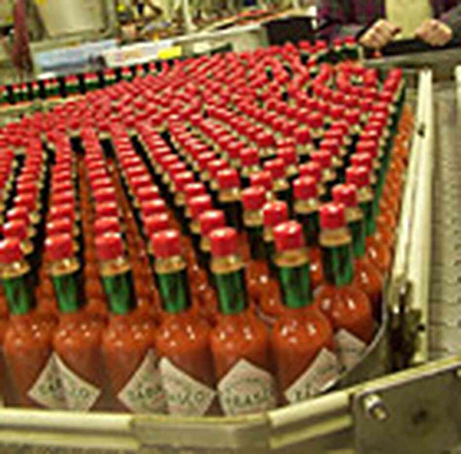 TABASCO bottles on the assembly line. TABASCO bottles on the assembly line.