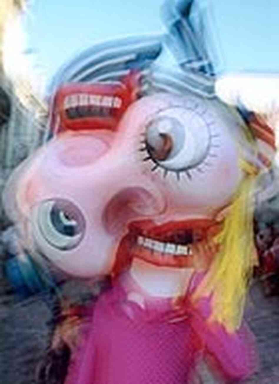 Klein photograph of a reveler wearing a giant head at a carnival in Paris Klein photograph of a reveler wearing a giant head at a carnival in Paris