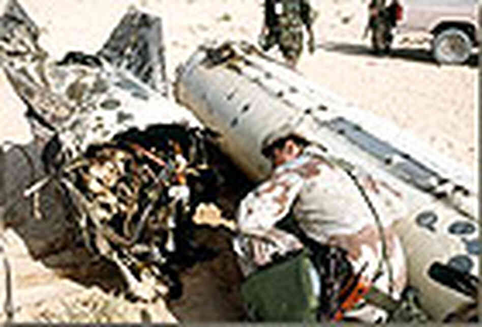 U.S. soldier inspects an Iraqi Scud missile. U.S. soldier inspects an Iraqi Scud missile.