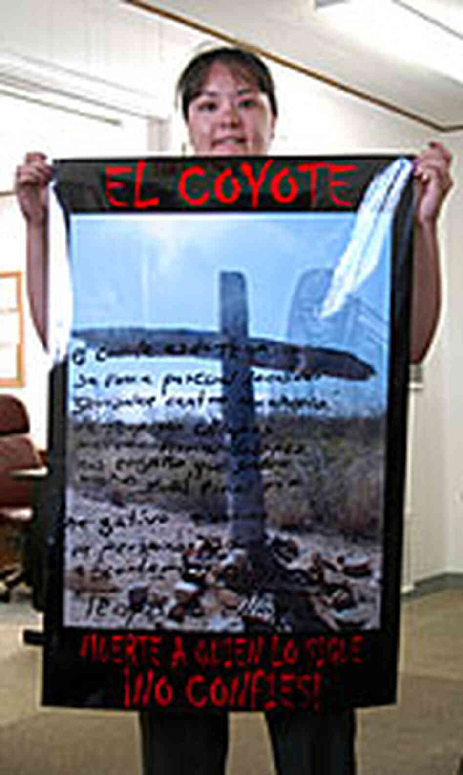 A Border Patrol agent holds a poster designed to dissuade migrants from trying to cross the desert. A Border Patrol agent holds a poster designed to dissuade migrants from trying to cross the desert.