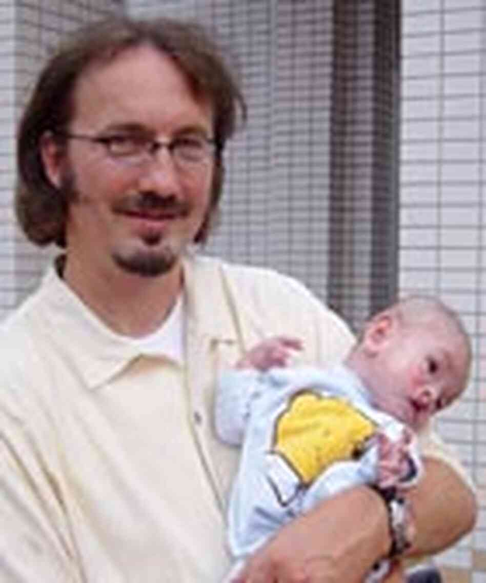 Tim Baker with a newly arrived orphan baby. Tim Baker with a newly arrived orphan baby.