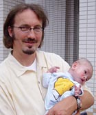 Tim Baker with a newly arrived orphan baby.