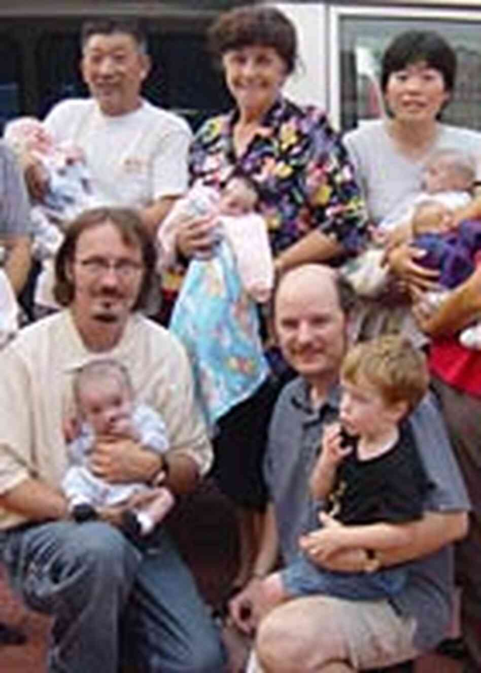 Tim Baker, John Bentley and other aid workers, with orphans.