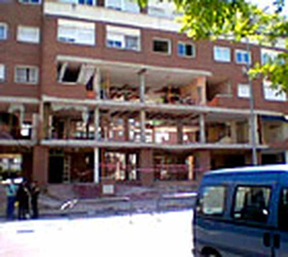 Facade of apartment building damaged during standoff between police and suspected terrorists. Facade of apartment building damaged during standoff between police and suspected terrorists.