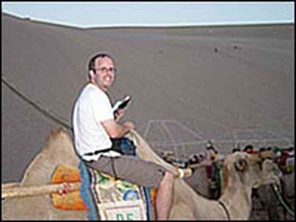 NPR's Rob Gifford plays tourist in the sand dunes of China's Gobi Desert. NPR's Rob Gifford plays tourist in the sand dunes of China's Gobi Desert.