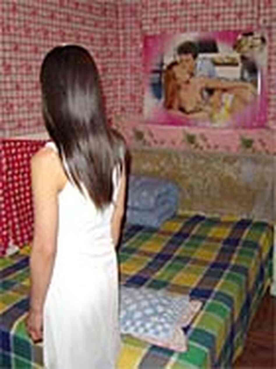 A prostitute in a room behind a hair salon.