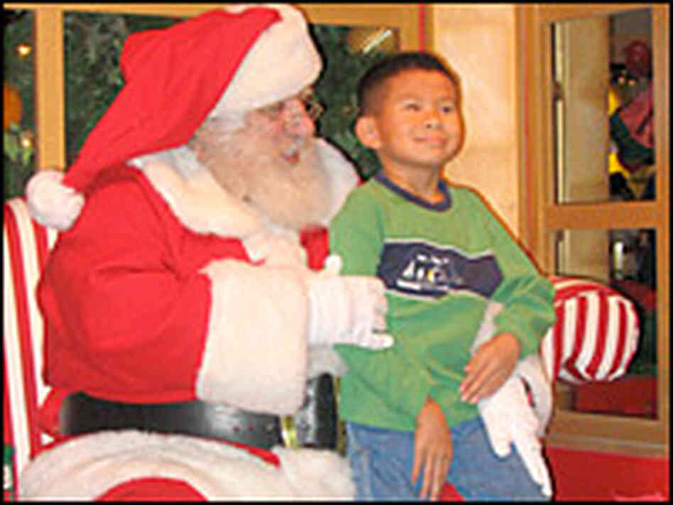 A Cherry Hill Photo Santa entertains 8-year-old Jerry Nguyen. A Cherry Hill Photo Santa entertains 8-year-old Jerry Nguyen.