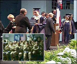 Chris Hochstetler of Shoemaker High School in Killeen, Texas, receives his diploma as soldiers, including his stepfather, look on from Baghdad via a videoconferencing hookup; Video still courtesy Killeen Independent School District