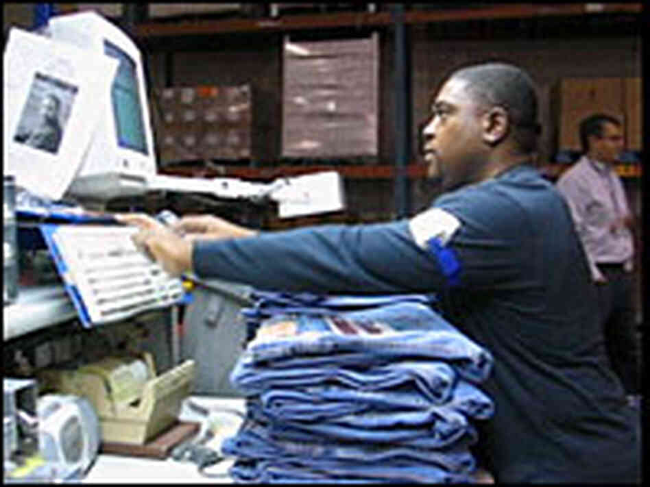 A worker in the Levi's plant processes stacks of jeans. Elaine Korry, NPR A worker in the Levi's plant processes stacks of jeans. Elaine Korry, NPR