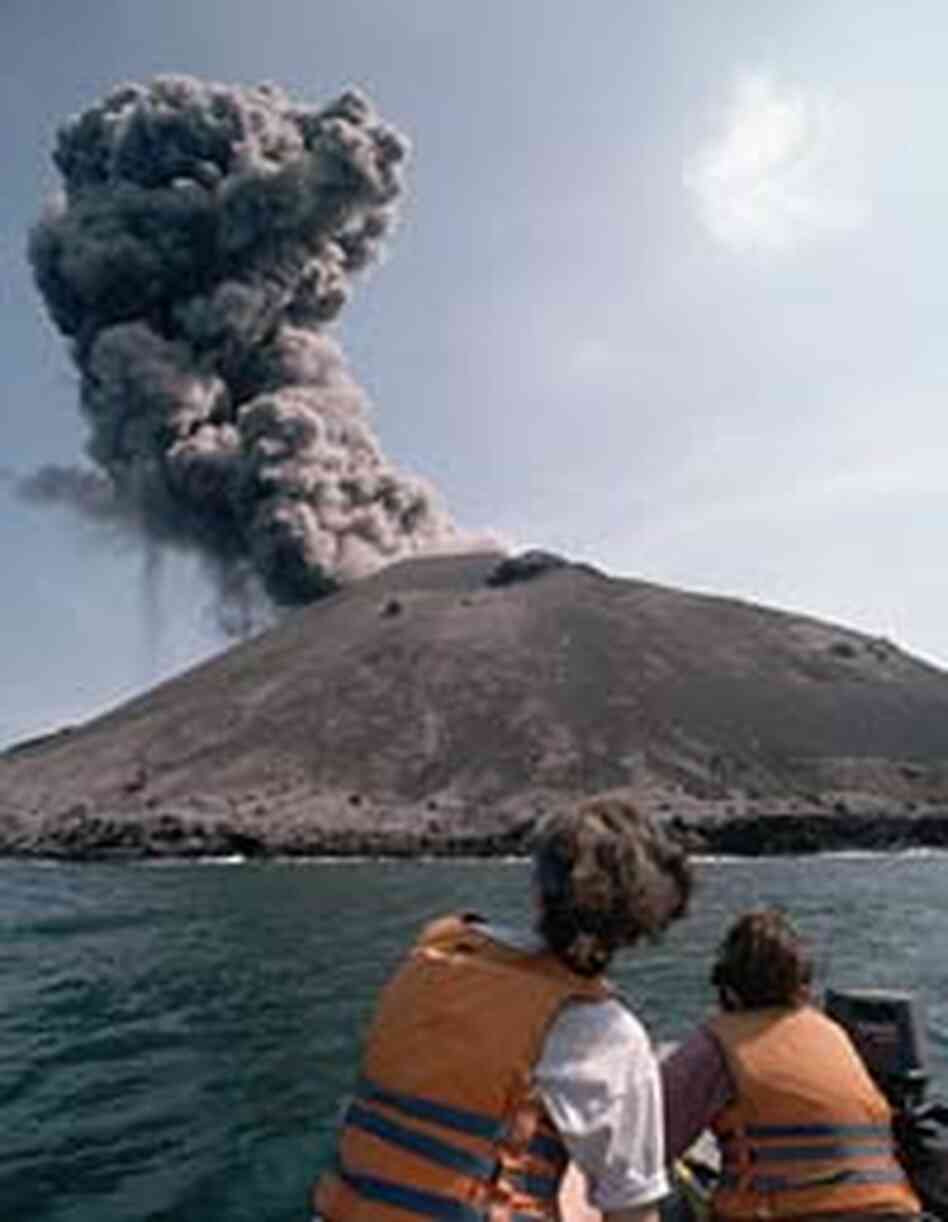 Tourists watch as smoke billows from a minor eruption of Anak Krakatau in 1995. Tourists watch as smoke billows from a minor eruption of Anak Krakatau in 1995.