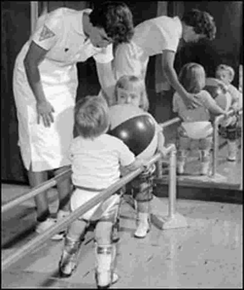 A physical therapist works with two polio-stricken children in the 1950s. A physical therapist works with two polio-stricken children in the 1950s.