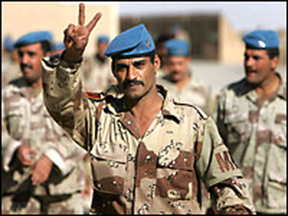 An Iraqi soldier gives the "V" sign before voting for parliament. Credit: Bob Strong-Reuters.
