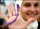 An Iraqi woman shows her ink-stained finger after casting her vote. Credit: Reuters-Ali Jarekji. An Iraqi woman shows her ink-stained finger after casting her vote. Credit: Reuters-Ali Jarekji.