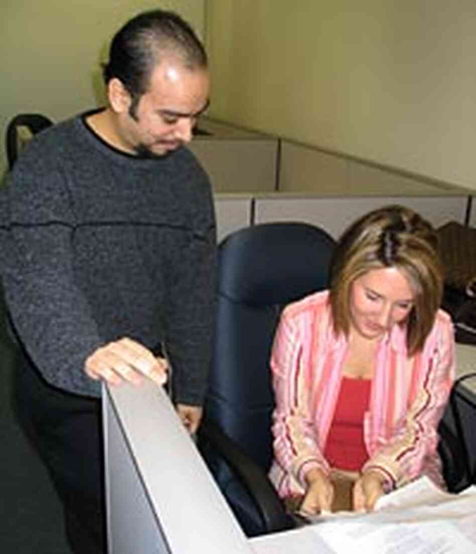 Program analyst Luis Medina, left, and systems analyst Kristina Madison Program analyst Luis Medina, left, and systems analyst Kristina Madison