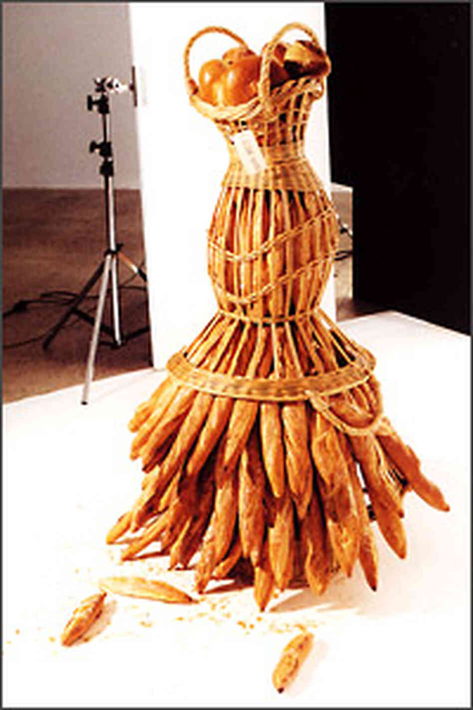 Here, a bread basket and baguettes bring to mind a woman wearing a skirt.