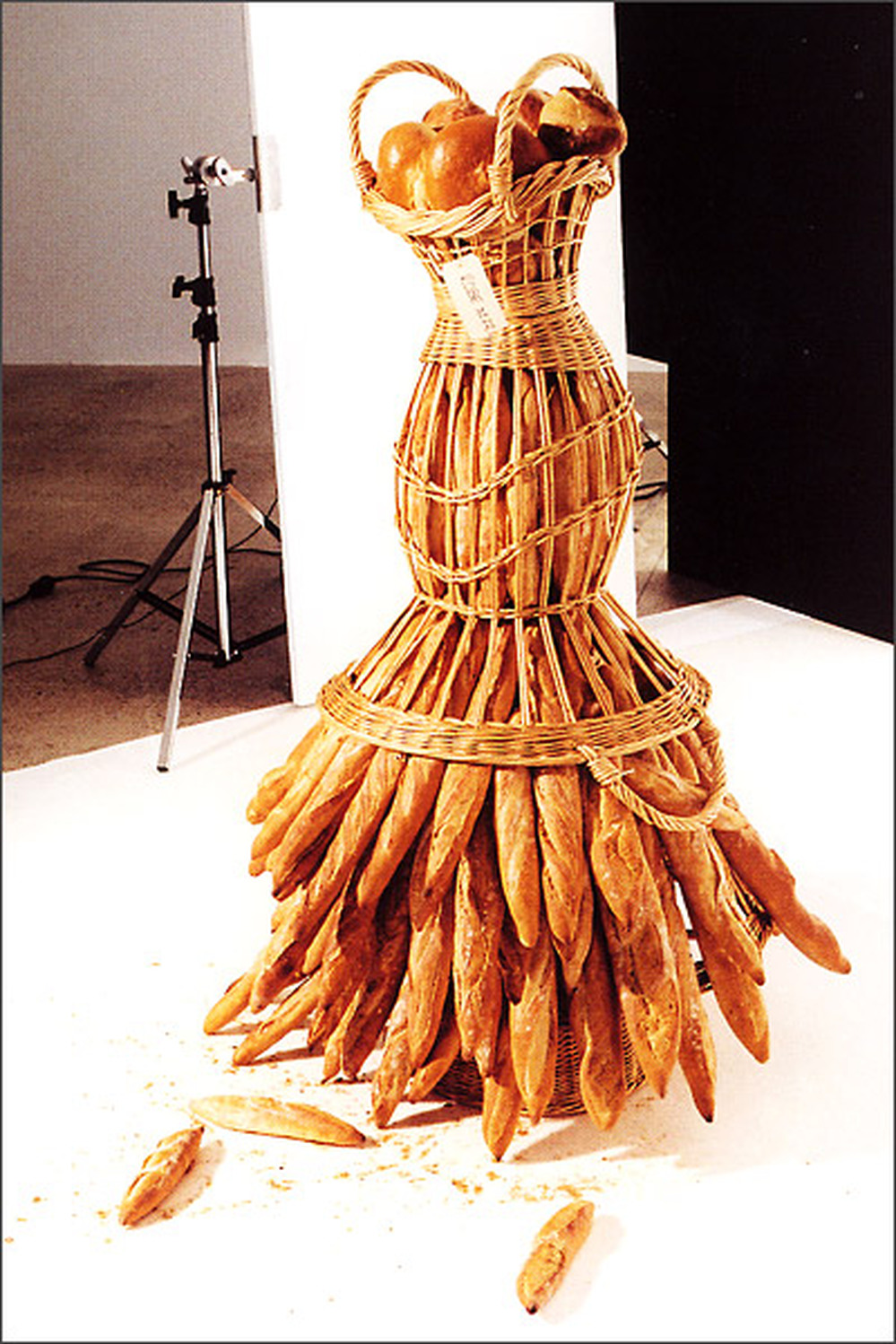 Here, a bread basket and baguettes bring to mind a woman wearing a skirt.