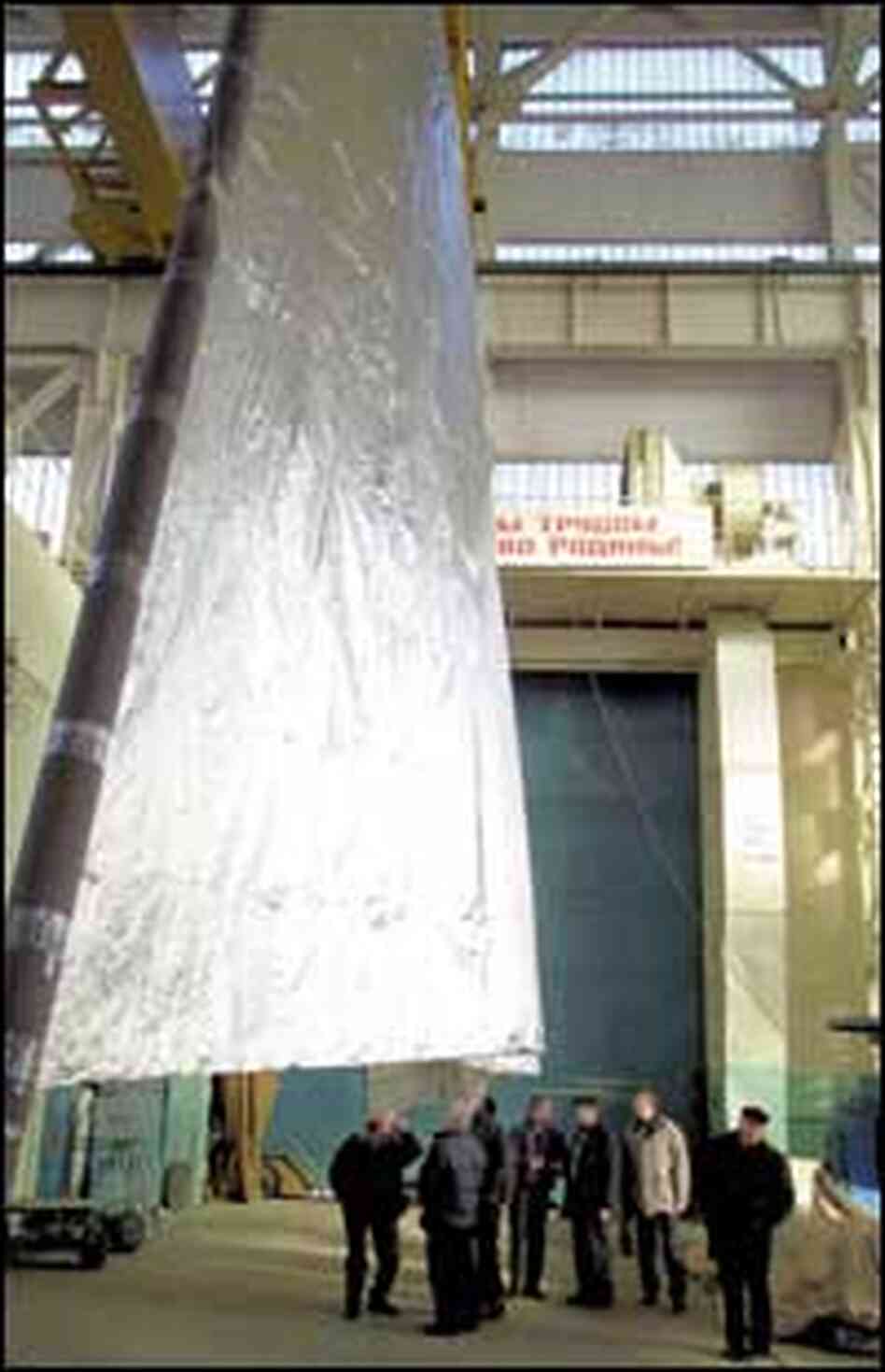 Engineers watch a zero-gravity simulation of the Cosmos 1's sail deployment in Jan. 2001 Engineers watch a zero-gravity simulation of the Cosmos 1's sail deployment in Jan. 2001