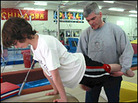 John Scanlan coaches gymnastics while looking for a job as a lawyer. John Scanlan coaches gymnastics while looking for a job as a lawyer.