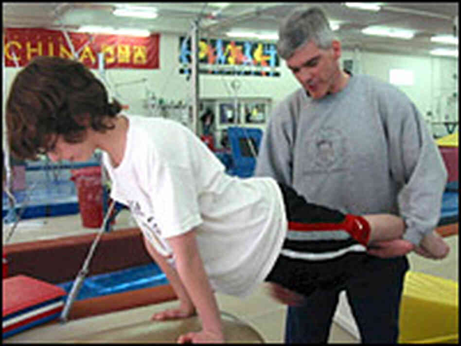John Scanlan coaches gymnastics while looking for a job as a lawyer. John Scanlan coaches gymnastics while looking for a job as a lawyer.