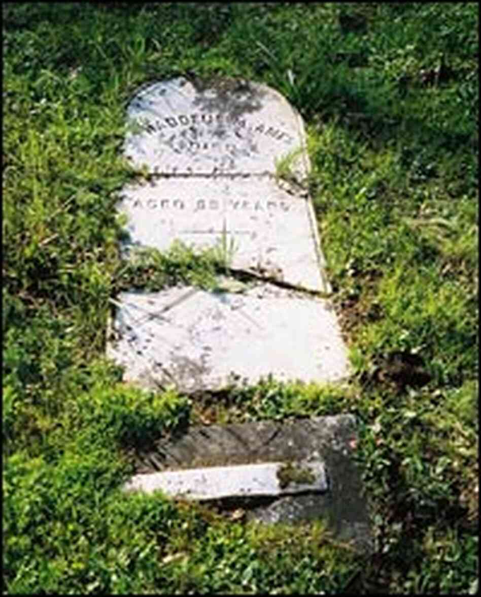 The broken headstone of Thaddeus Ames