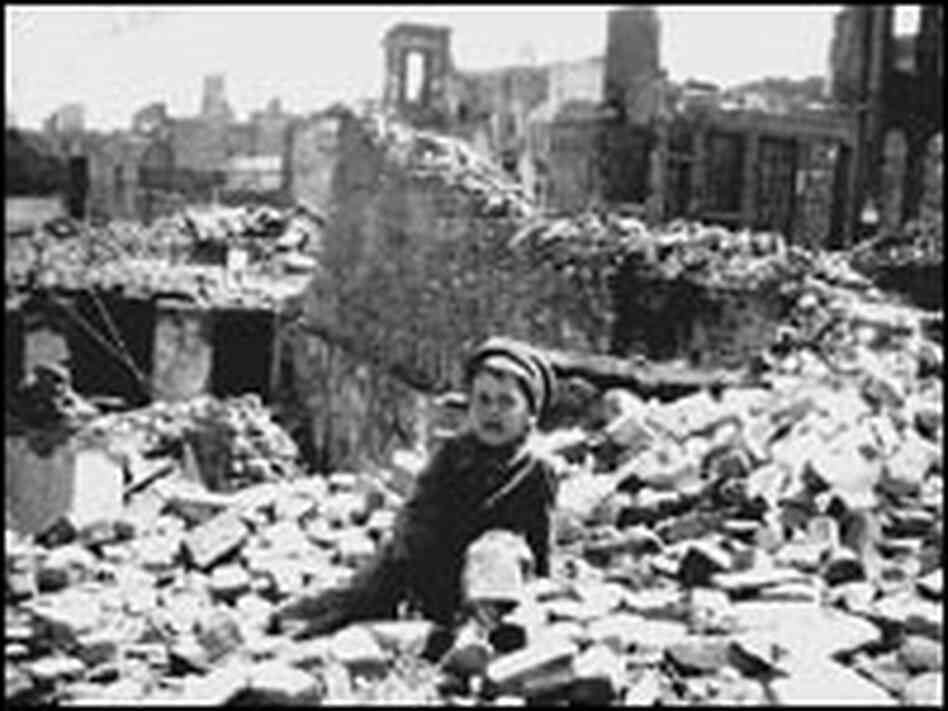 Dante Monaco sits in the rubble.