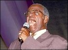 Sherman Washington sings in the Gospel Tent. Sherman Washington sings in the Gospel Tent.