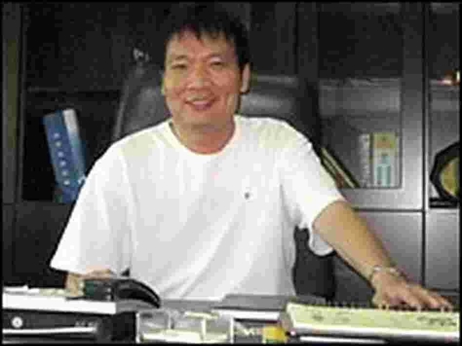 Wang Chunqiao, sitting behind his desk.