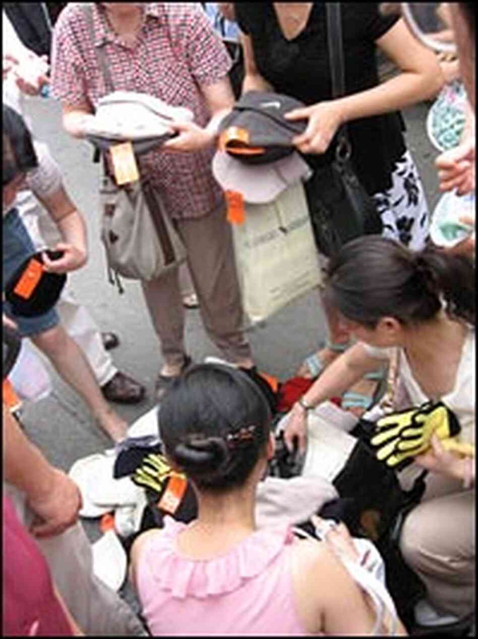 Local shoppers examine fake Nike merchandise in Shanghai's famous Xiangyang market.