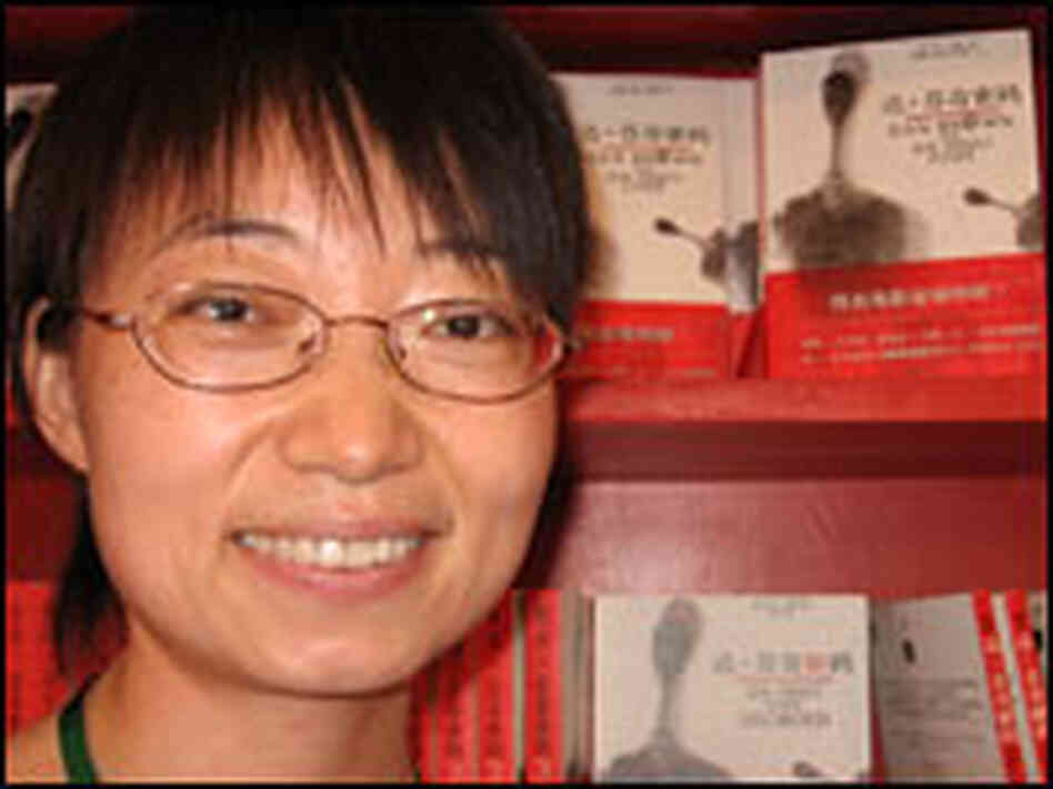 Karen Cao poses with legal copies of 'The Da Vinci Code.'