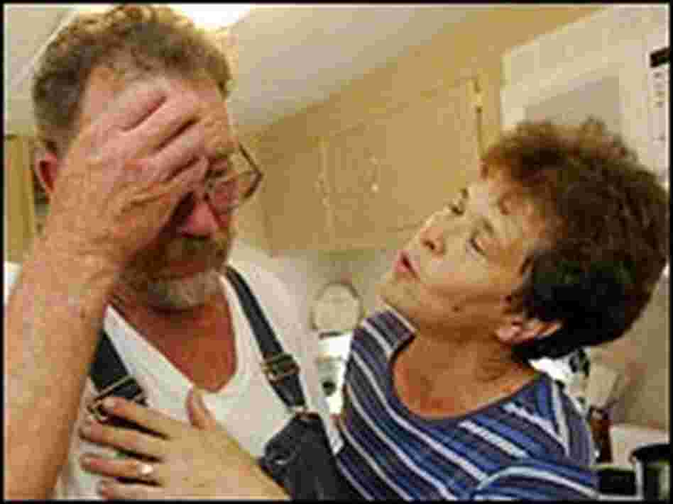 Donald and Colleen Bordelon share an emotional moment, in their kitchen of their home.