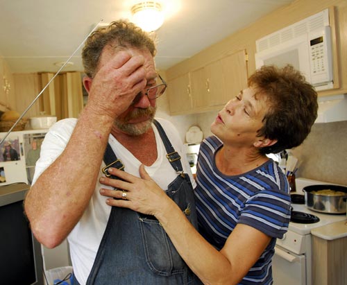 Donald and Colleen Bordelon share an emotional moment, in their kitchen of their home.