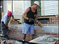 Bricklayers work on a house in Mid-City in New Orleans.