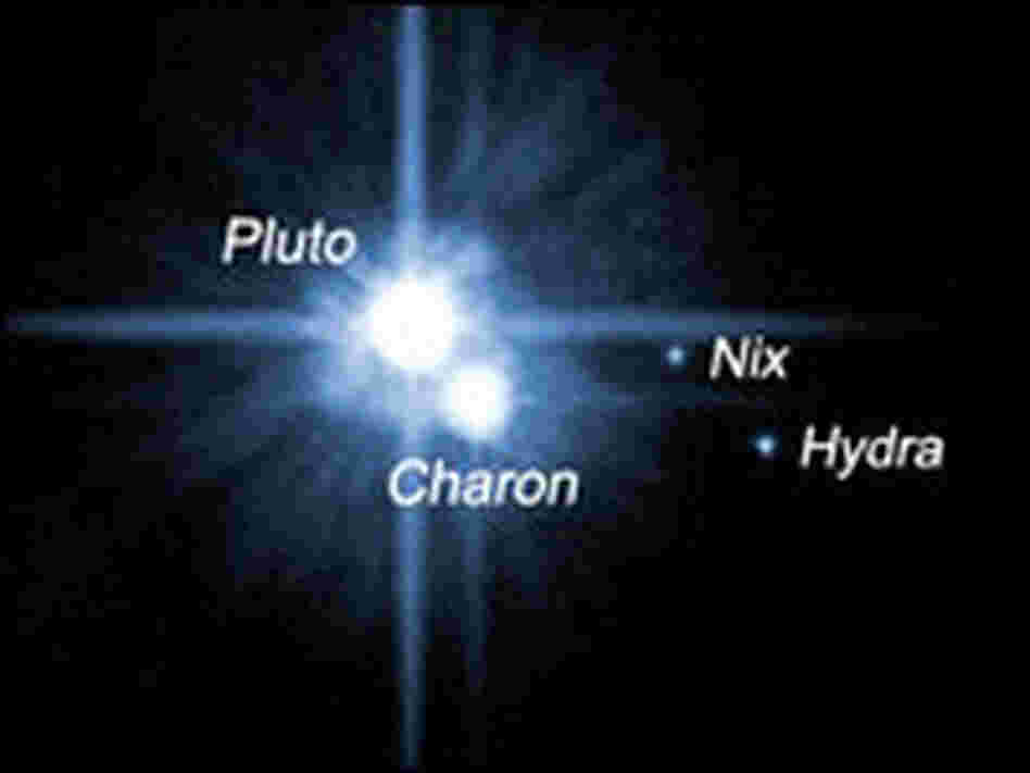 Pluto and its three known moons.