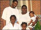 Anthony Polk, Alfreda Stewart and their three children stand in front of their home. Anthony Polk, Alfreda Stewart and their three children stand in front of their home.