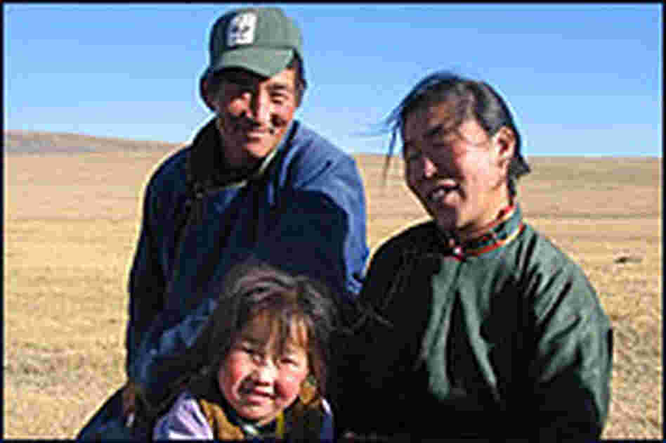 Erdenbaatar, a Mongolian wildlife ranger, with his wife and daughter