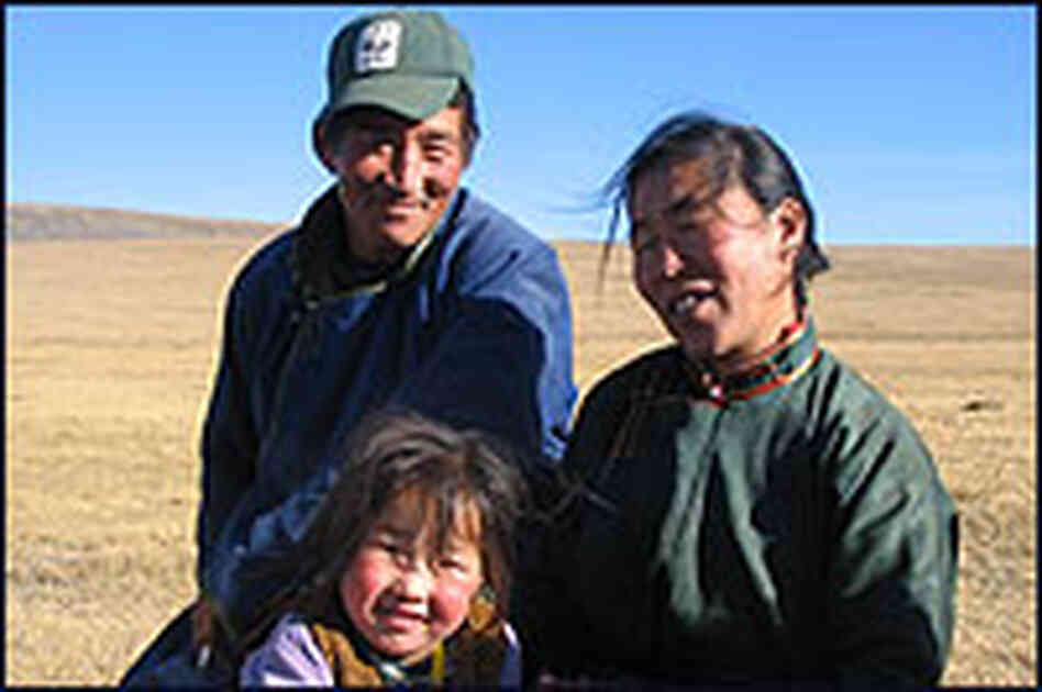 Erdenbaatar, a Mongolian wildlife ranger, with his wife and daughter