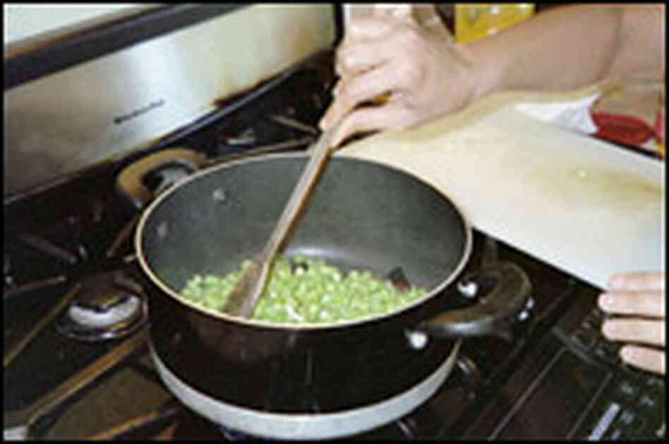 Green-bean thoren being prepared on a stove. Green-bean thoren being prepared on a stove.
