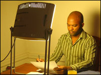 Andre Pennycooke sits in front of his light box, the Day Light DL930 from Uplift Technologies.