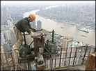 A man goes about his work on the construction site of the Shanghai World Financial Center